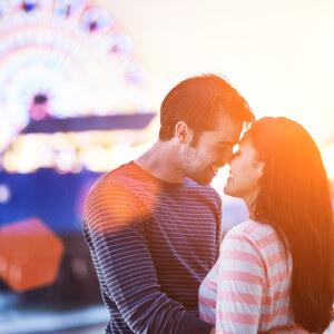 romantic couple with santa monica pier in background.