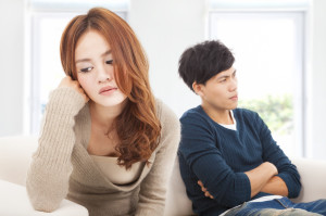 young Couple sitting on the sofa during conflict