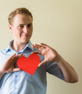 young guy holding a heart