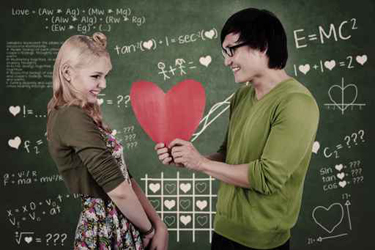 Cute nerd guy and girl holding heart in classroom
