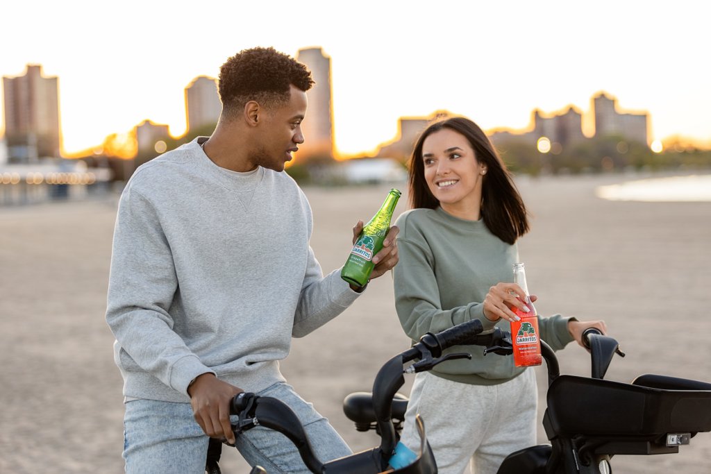 A man and woman sitting on bicycles and talking