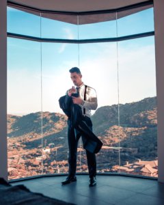 Man in suit standing in front of a great view