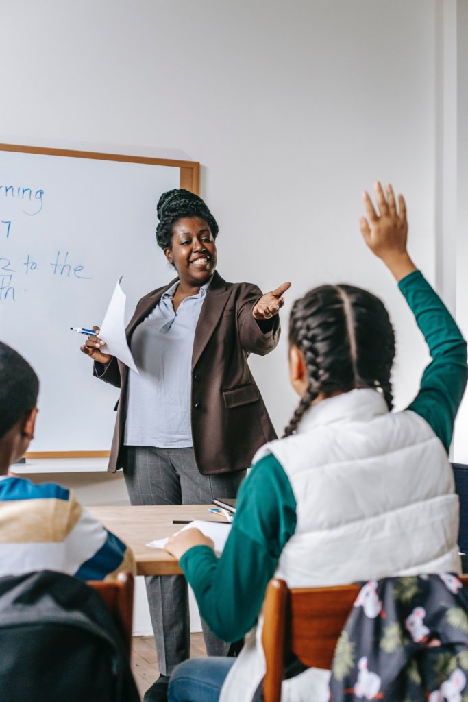 A female teacher calling on a student in class