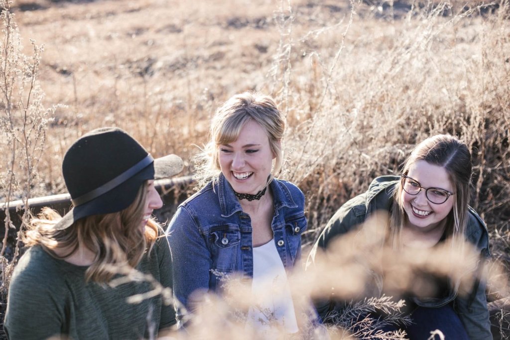 Three women laughing together outdoors